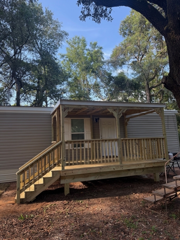 Front Porch featuring Integrated Shed Roof and Vertical Picket Railing