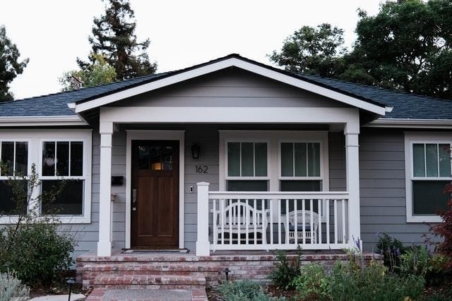Gray Craftsman Style Home featuring Brick Porch Steps and Landscaping