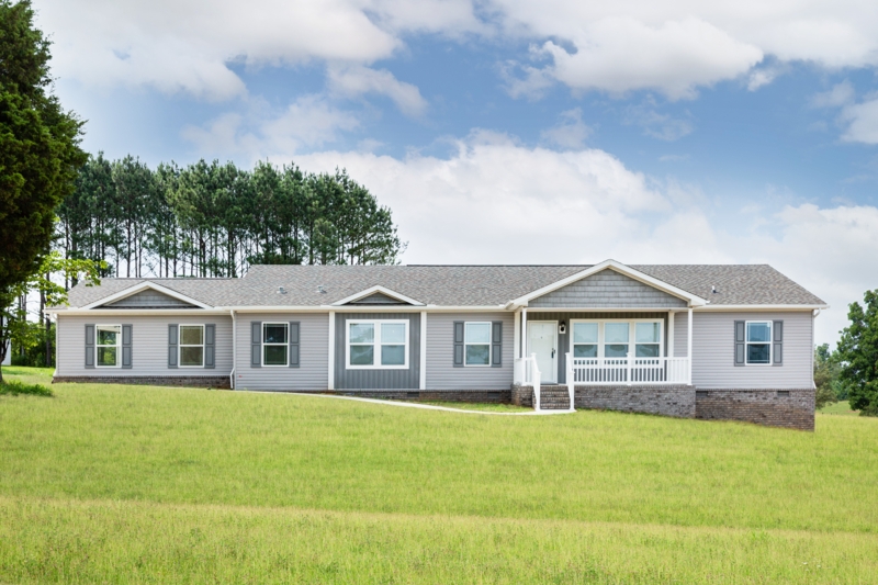Gray Manufactured Home with Brick Foundation and Porch