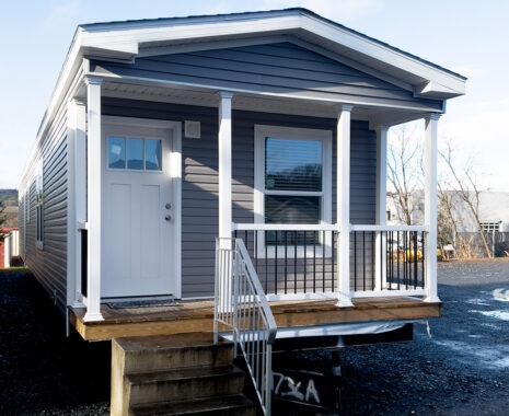 Gray Manufactured Home with Porch and White Columns