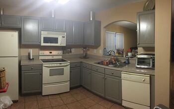 Gray Painted Cabinets in L-Shaped Kitchen with Arched Pass-Through Window