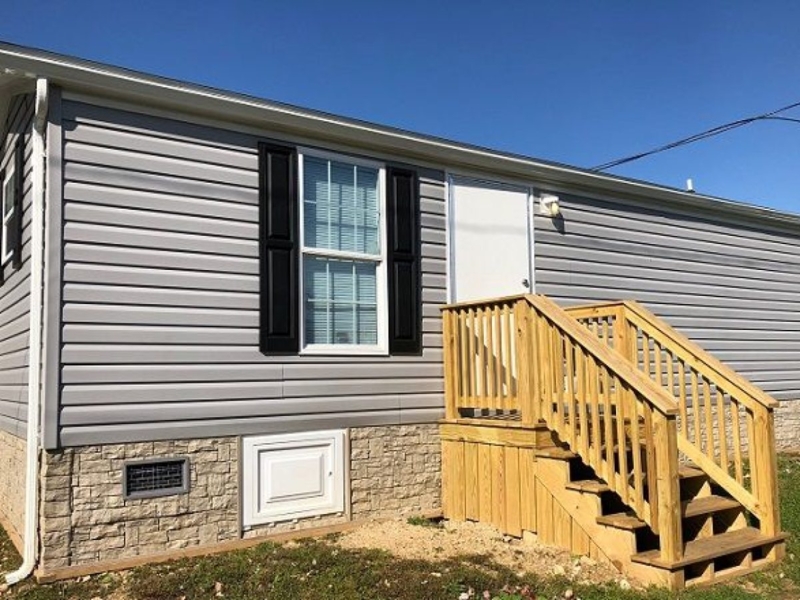 Gray Siding with Stone Veneer Skirting and Black Shutters
