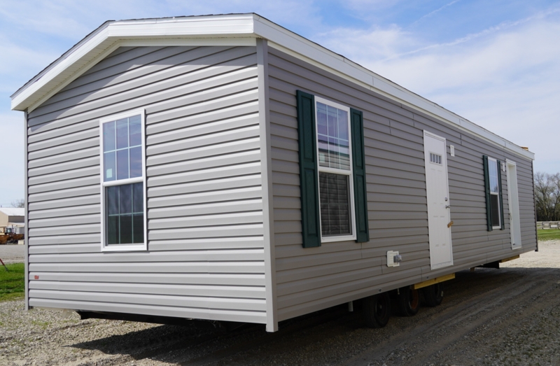 Gray Single Wide Mobile Home with Dark Green Shutters