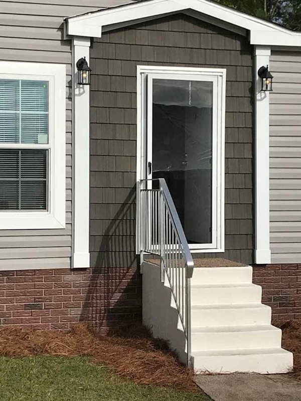 Home Exterior Entryway Featuring Shake Siding Accent and Brick Skirting