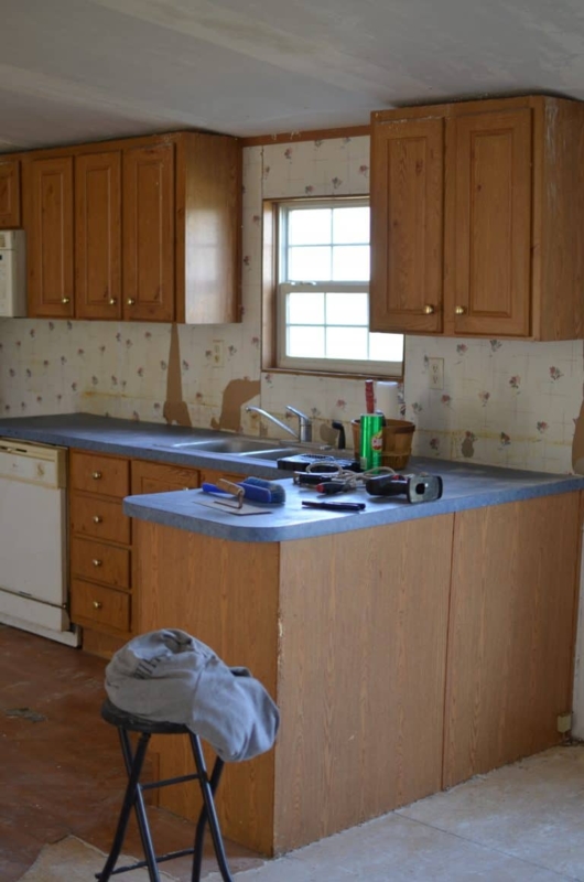Honey Oak Cabinets Layout: Blue Countertops and Vintage Wallpaper