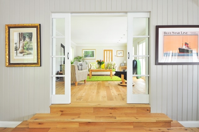 Honey Oak Hardwood Flooring Ideas with White French Doors and Paneling