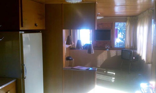Honey Wood Paneling and Pendant Lights in Mid-Century Mobile Home