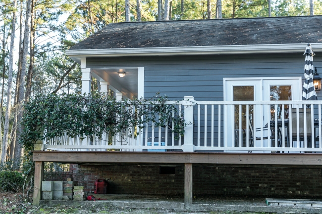 House Exterior with Large Wooden Deck & White Railing