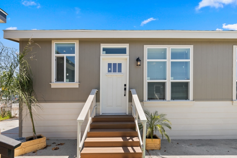 House Exterior with White Front Door, Wooden Stairs, and Two Tone Siding