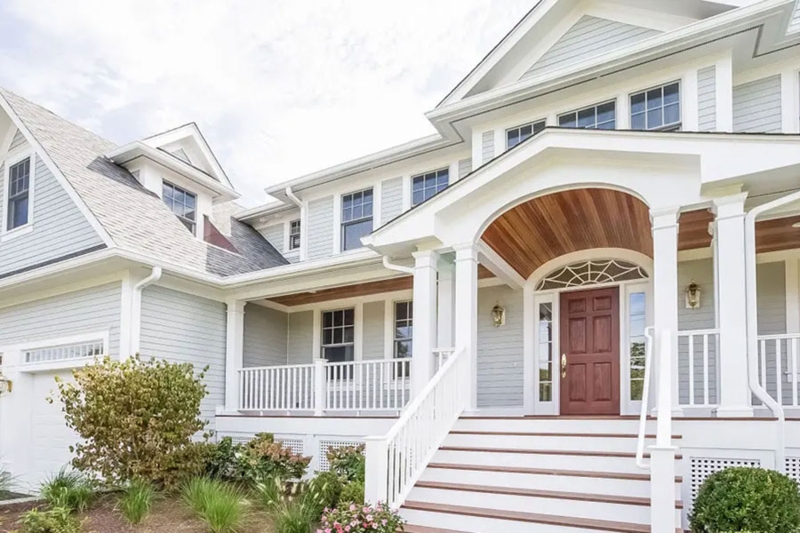House with Arched Wood Ceiling Porch and Expansive Front Stairs.