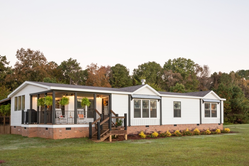 Integrated Porch on Manufactured Home with Brick Skirting and Black Trim