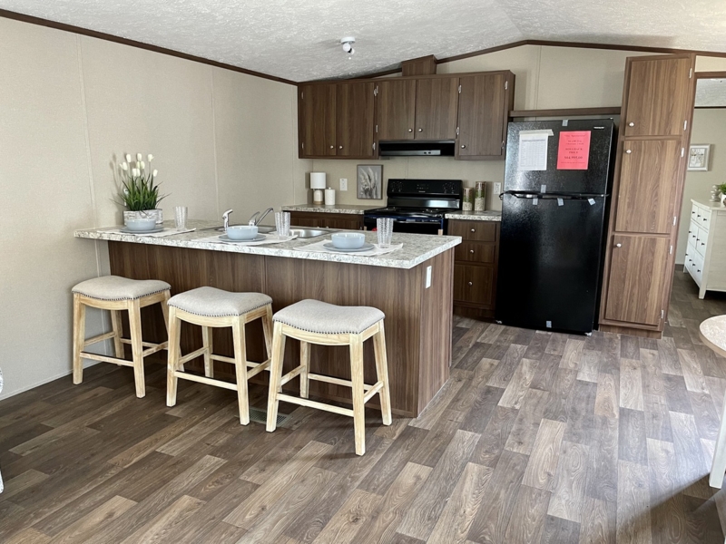 Kitchen Island with Backless Stools and Dark Wood Toned Cabinets