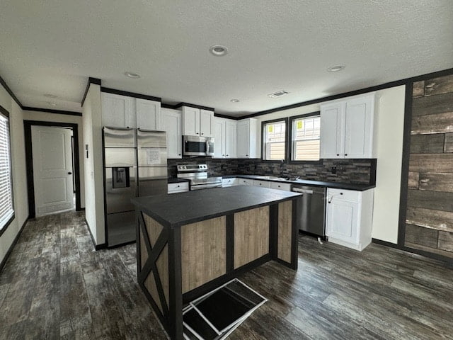 Kitchen Island with Black X Brace Detail and Rustic Wood Accent Wall.