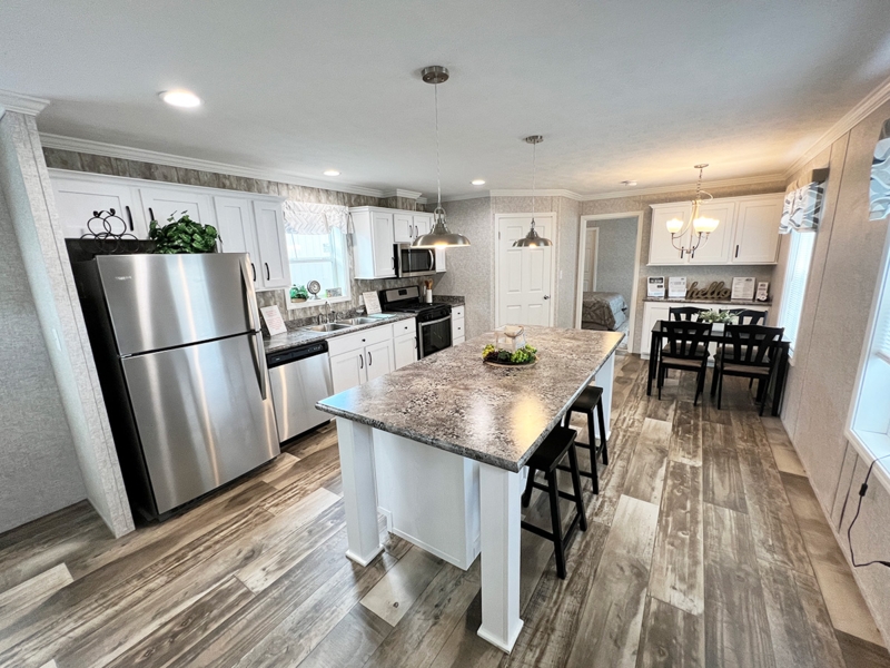 Kitchen Island with Mottled Stone Top and White Shaker Cabinetry