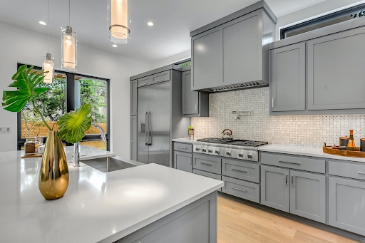 Kitchen Modern Gray Cabinetry with Gold Accent and Large Island