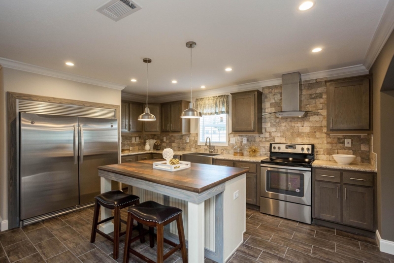 Kitchen with Textured Stone Backsplash and Dark Shaker Cabinets