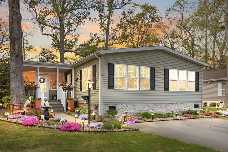 Landscaping with Vibrant Pink Floral Borders and Stone Skirting