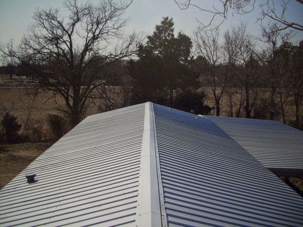 Light Gray Corrugated Metal Roof with Prominent Ridge Cap