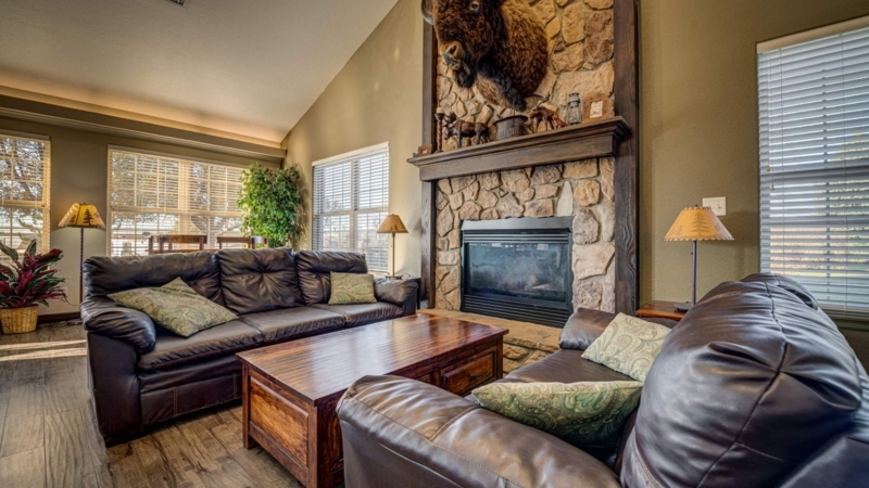 Lodge Style Living Room with Stone Fireplace and Bison Head Mount