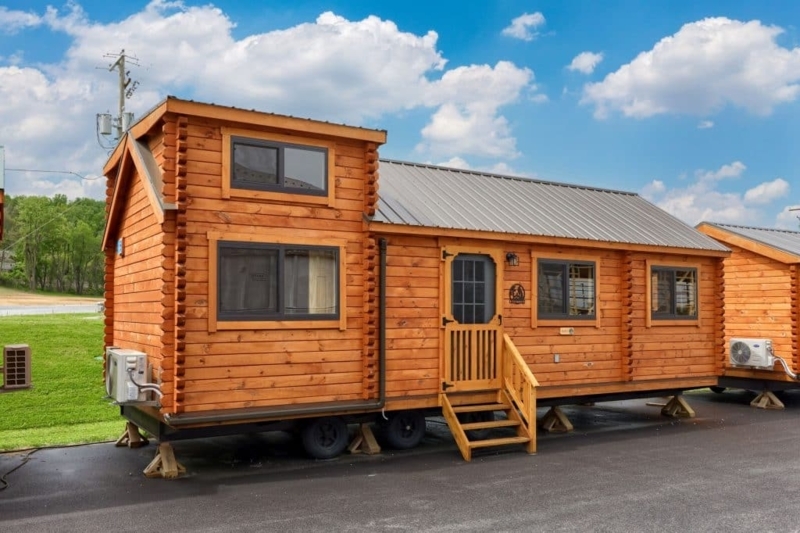 Lofted Tiny House on Wheels with Log Siding and Metal Roof