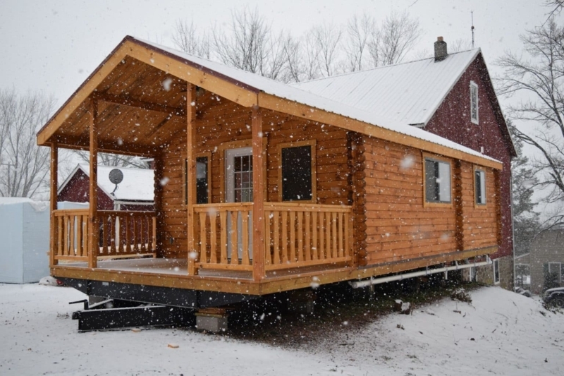 Log Cabin on Elevated Chassis in Snowy Landscape