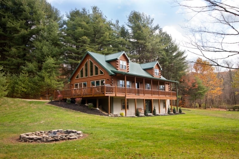 Log Cabin with Wraparound Porch and A-Frame Window Wall