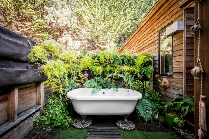 Lush Garden Soaking Tub Retreat with Clawfoot Base and Ferns