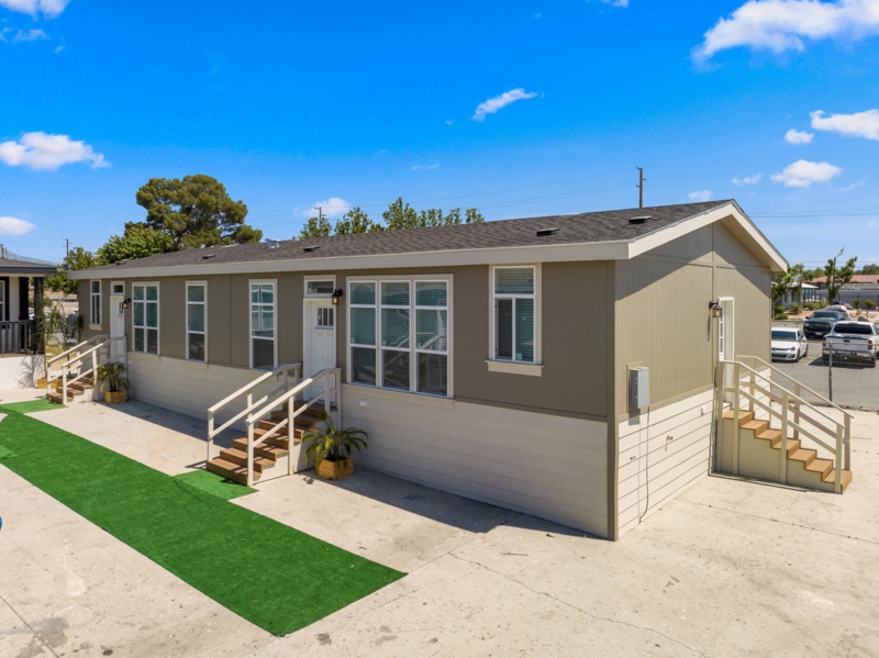 Manufactured Duplex Dual Tone Exterior with Wooden Entry Stairs and Turf