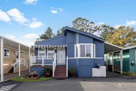 Manufactured Home Coastal Slate Blue Siding with White Picket Railing