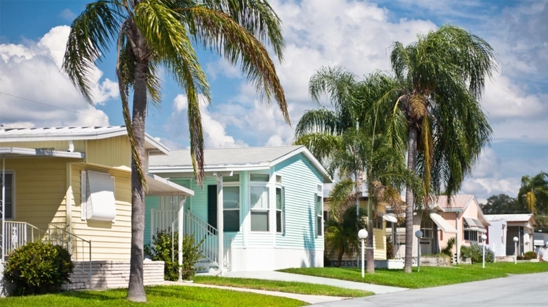 Manufactured Home Community with Pastel Exterior Colors and Palm Trees.