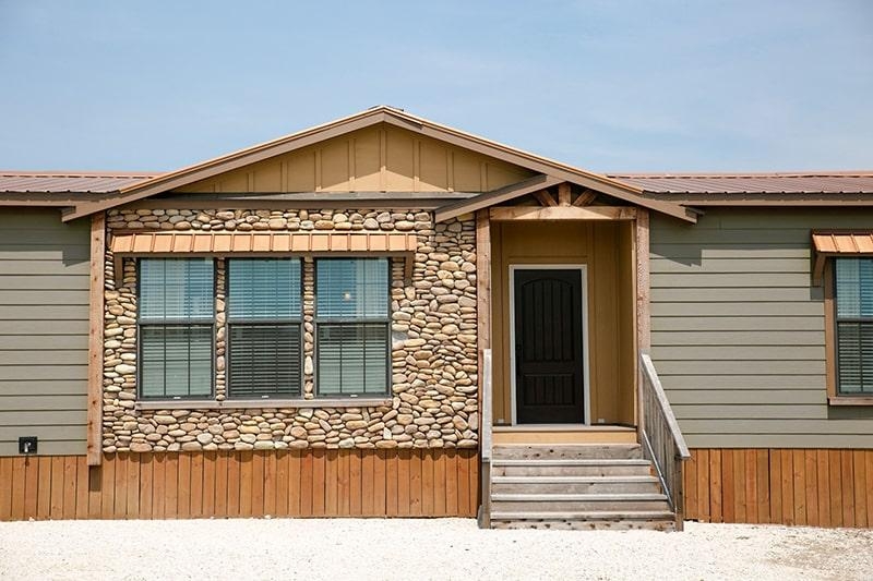 Manufactured Home Exterior: Mixed Material Stone Veneer & Wood Skirting