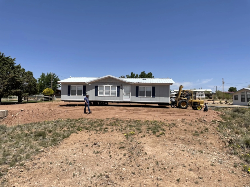 Manufactured Home Exterior: Navy Shutters & White Metal Roofing