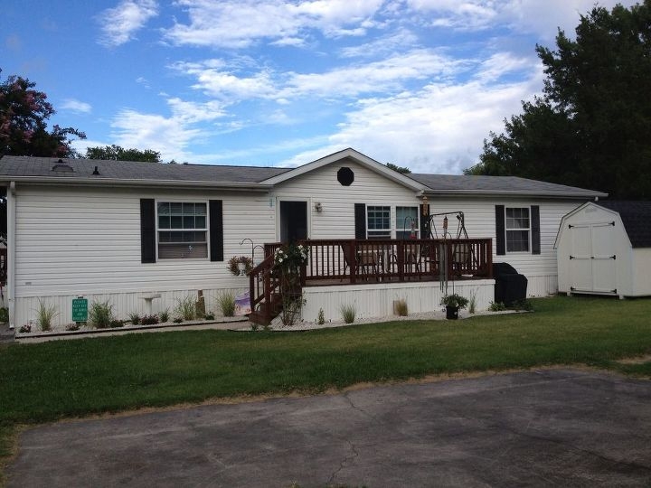 Manufactured Home Exterior: White Siding, Dark Shutters, Raised Deck