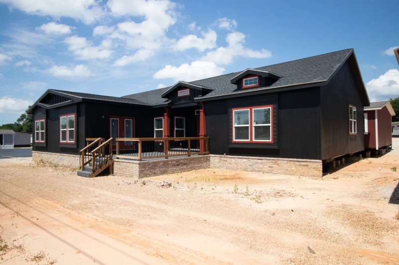 Manufactured Home Exterior with Bold Red Trim and Decorative Dormers