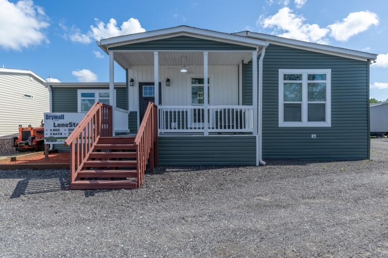 Manufactured Home Exterior with Green Vinyl Siding & Red Wooden Steps