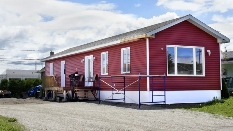 Manufactured Home Renovation: Vibrant Red Siding with White Skirting