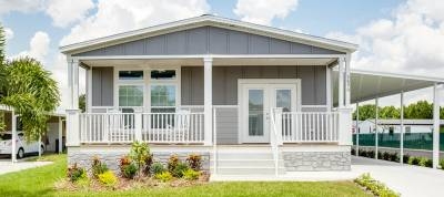 Manufactured Home with Carport and Stone Look Skirting Exterior