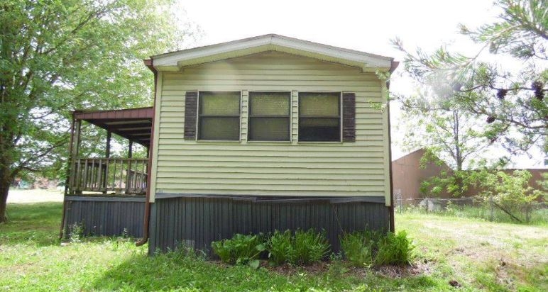 Manufactured Home with Covered Side Porch and Dark Skirting Contrast