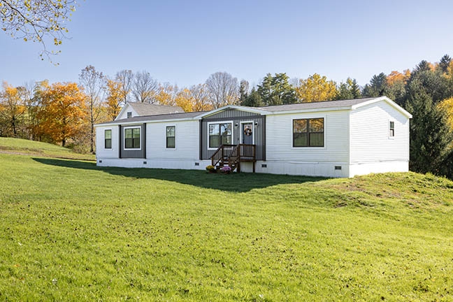 Manufactured Home with High Contrast Accents and Skirted Foundation