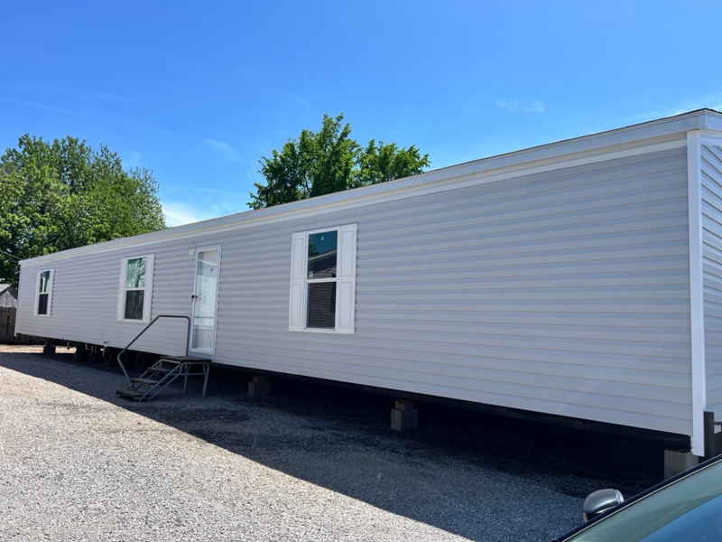 Manufactured Home with Light Grey Vinyl Siding and White Shutters