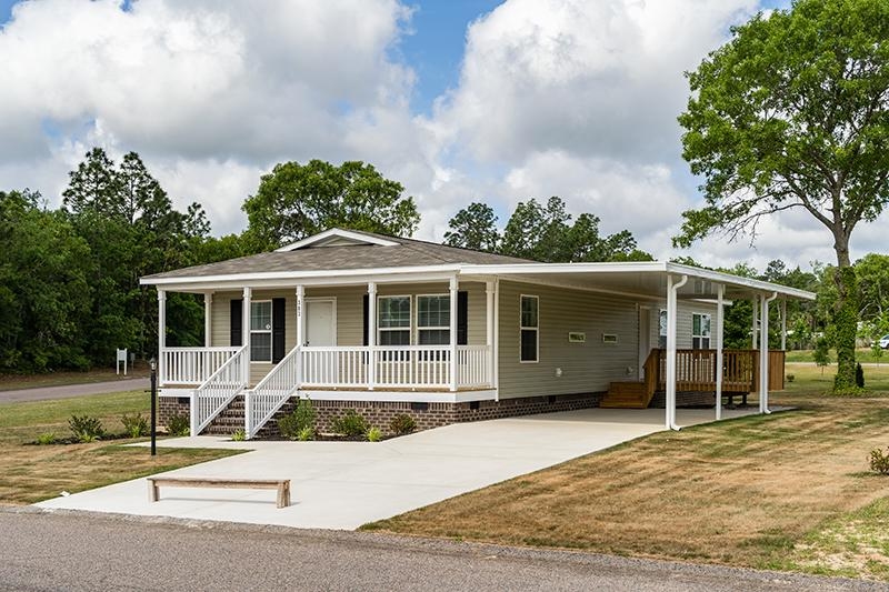 Manufactured Home with Porch and Attached Carport Structure