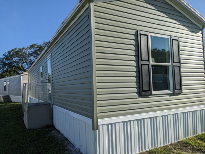 Manufactured Home with Sage Green Siding and Black Decorative Shutters