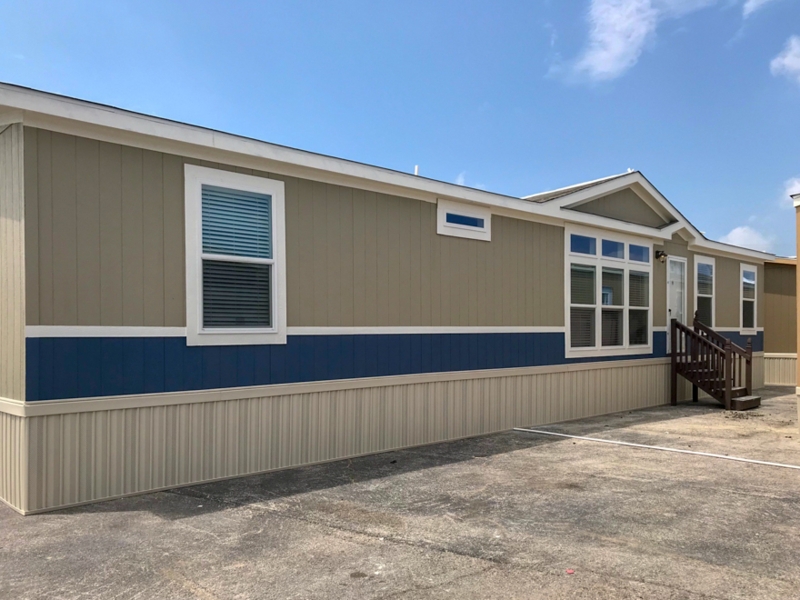 Manufactured Home with Vertical Tan Siding and Navy Horizontal Band