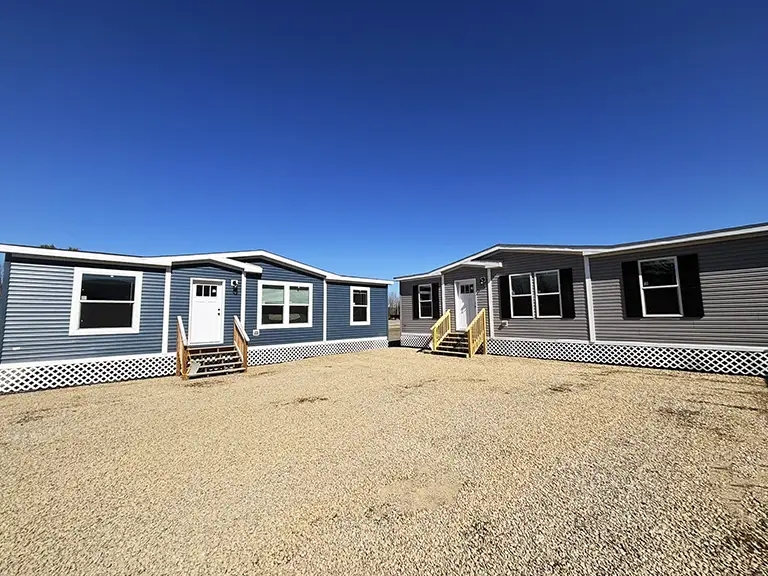 Manufactured Homes with Neutral Siding Variety on Gravel Lot