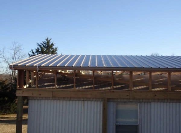 Metal Roof Structure Over Wood Truss System with Ribbed Panels