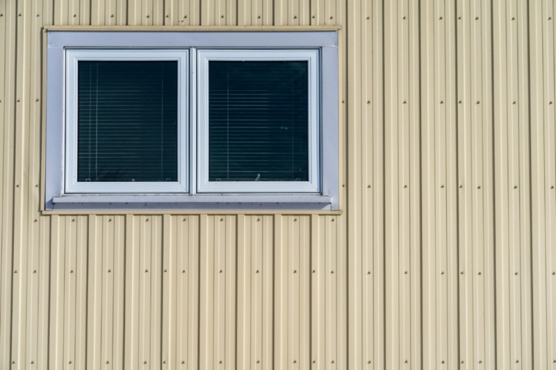 Metal Siding Detail: Cream Corrugated, Ribbed Surface