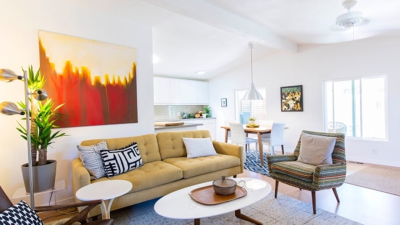 Mid-Century Modern Living Room features Mustard Yellow Tufted Sofa