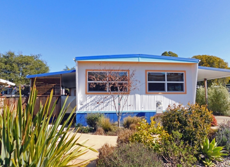 Mid-Century Renovation with Orange Window Frames and Corrugated Siding