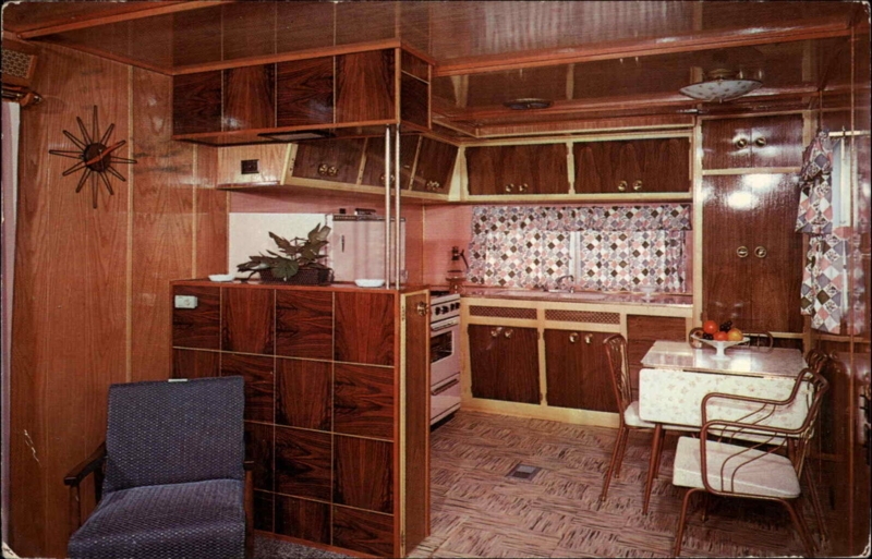 Mid-Century Trailer Kitchen with Wood Paneling and Starburst Clock