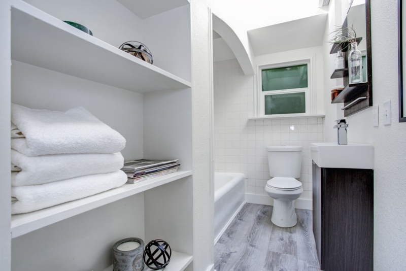 Minimalist Bathroom with Open Shelving and Compact Vanity Layout